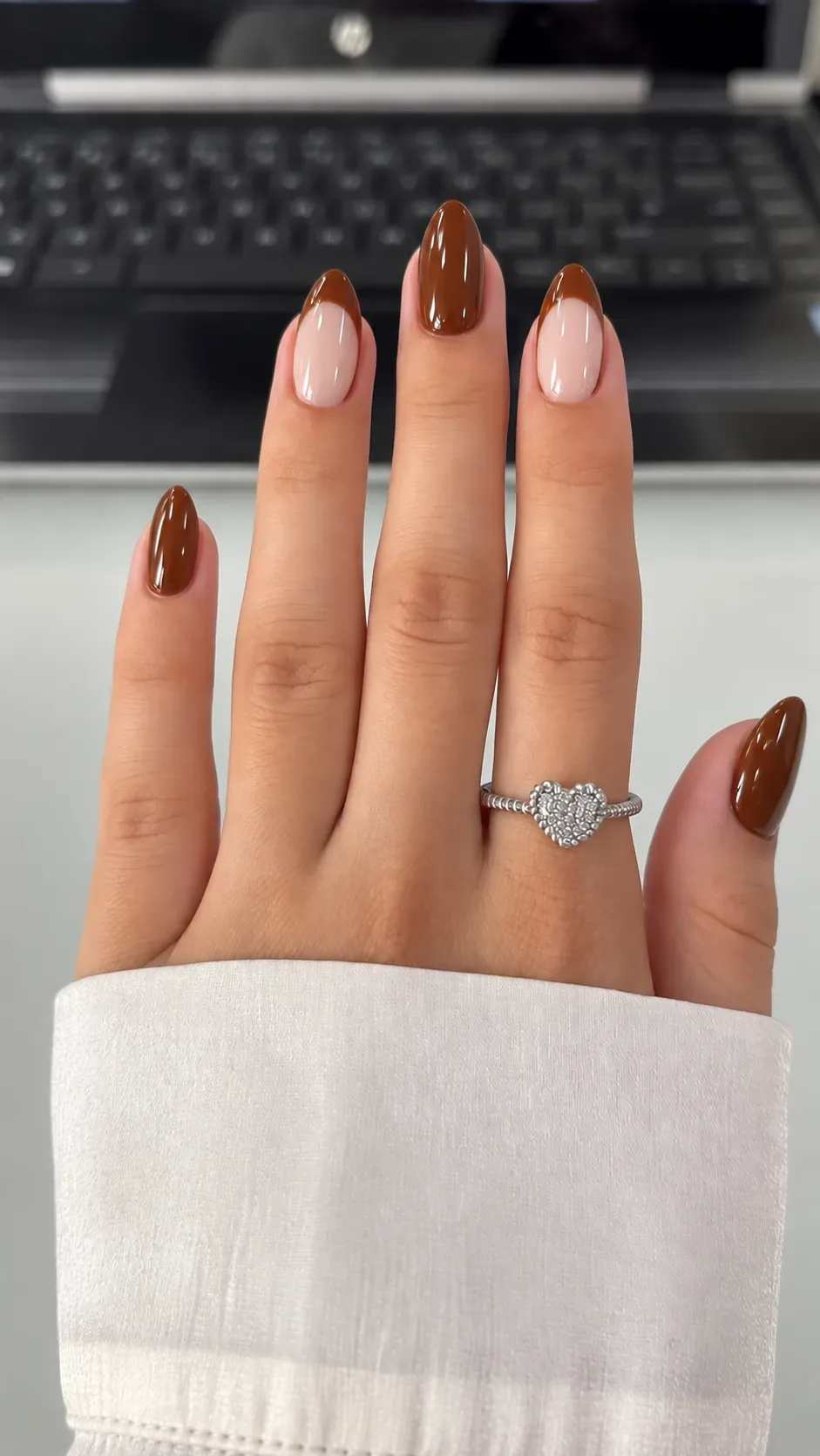 Fall almond nails with glossy chocolate brown french tips over sheer nude Fall almond nails with glossy chocolate brown french tips over sheer nude