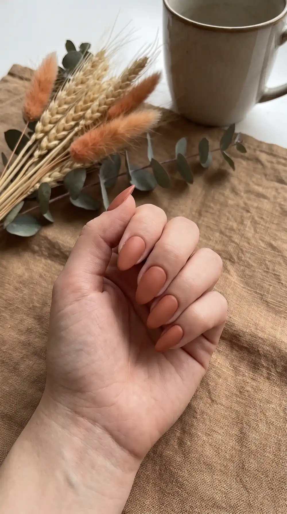 Matte terracotta fall almond nails with a soft clay finish Matte terracotta fall almond nails with a soft clay finish