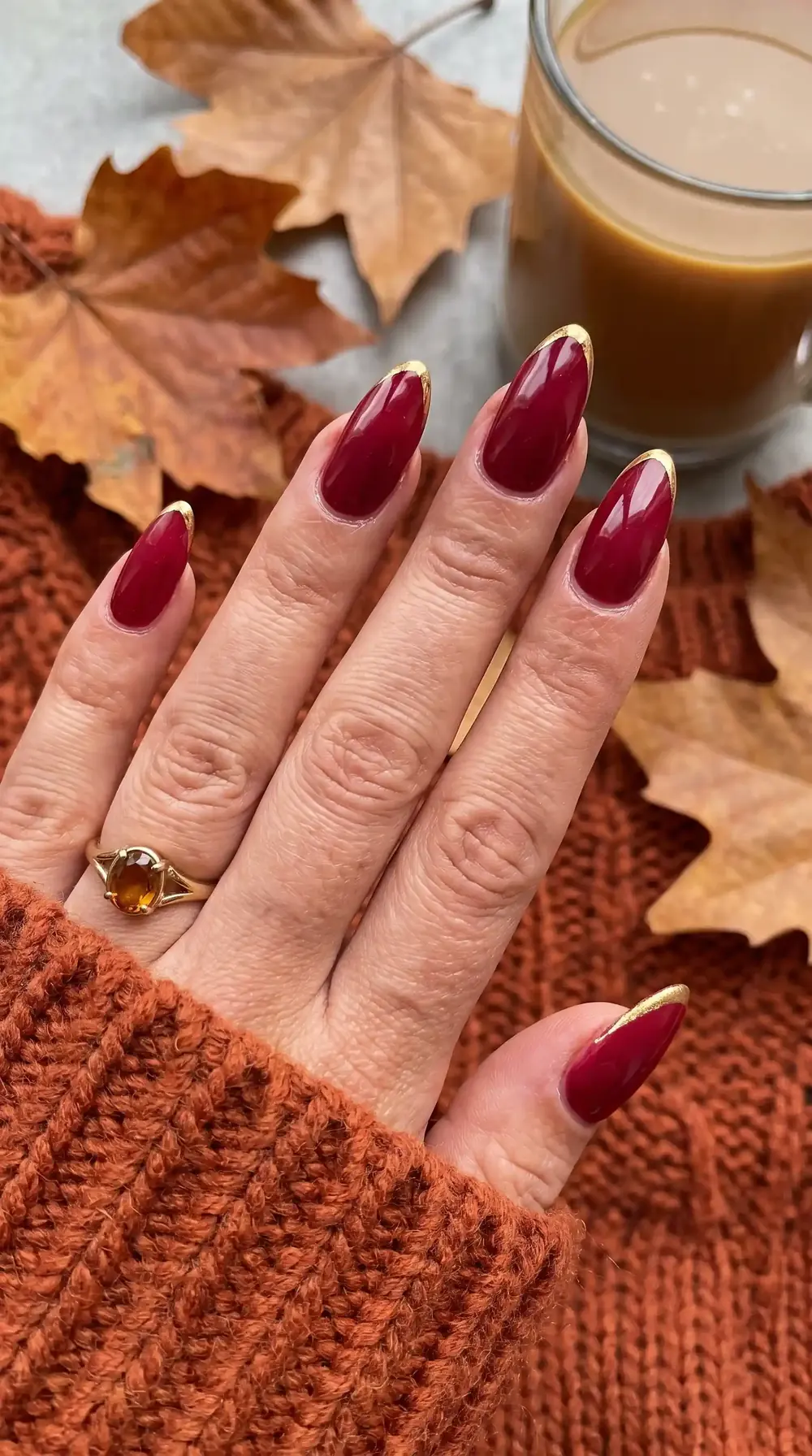 Wine red fall almond nails with gold tip accents Wine red fall almond nails with gold tip accents