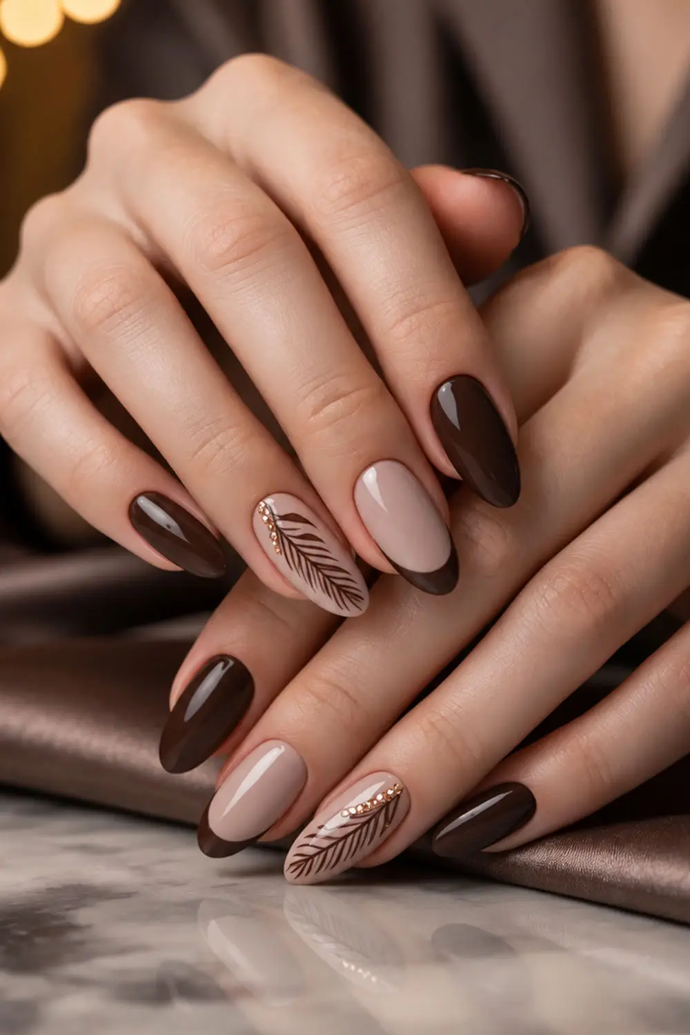 Short dark chocolate fall nails with a feather leaf accent Short dark chocolate fall nails with a feather leaf accent