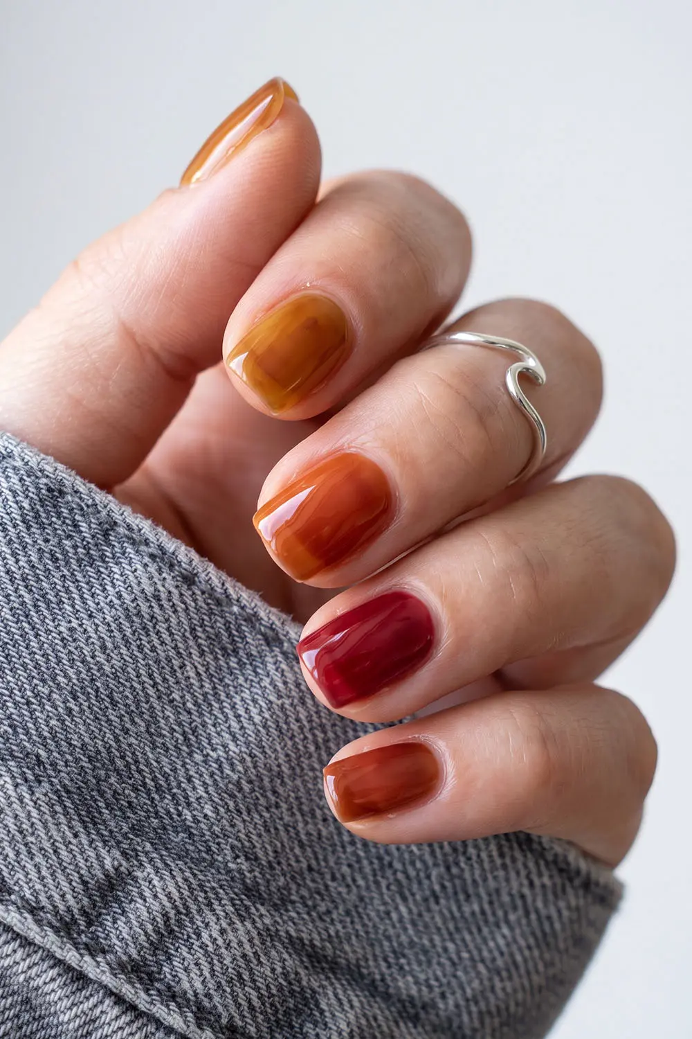 Short jelly finish fall nails in amber, orange and cranberry Short jelly finish fall nails in amber, orange and cranberry
