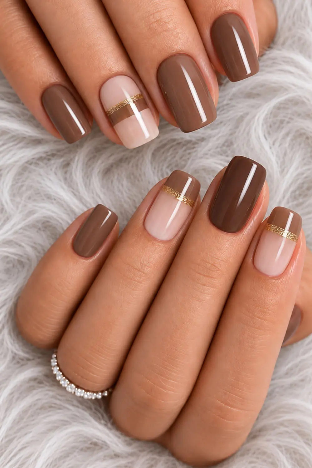 Short mocha and nude colour block fall nails with a gold stripe Short mocha and nude colour block fall nails with a gold stripe