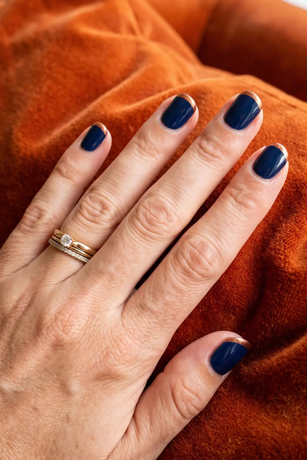 Short glossy navy blue fall nails on a warm autumn backdrop Short glossy navy blue fall nails on a warm autumn backdrop