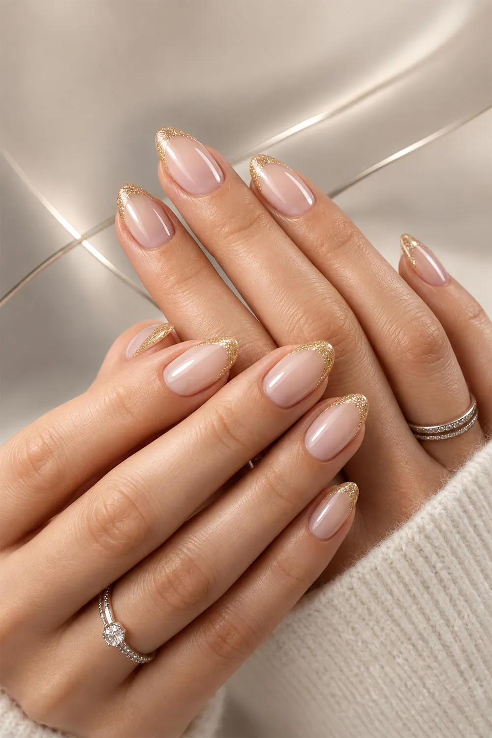 Short nude almond nails with a delicate gold tip finish Short nude almond nails with a delicate gold tip finish