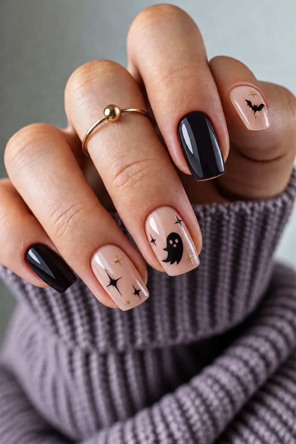 Short halloween nails in black and nude with ghost, bat and star details