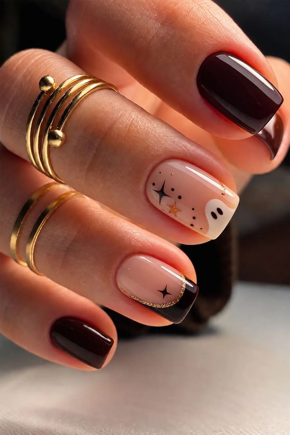 Dark burgundy short halloween nails with ghost and star accents on nude