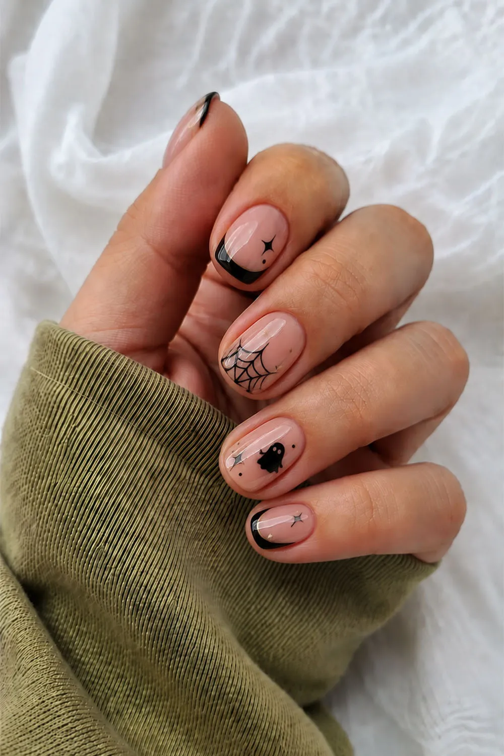 Nude short halloween nails with black french tips and tiny spiders
