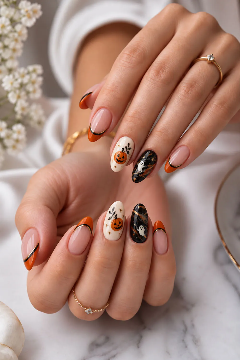 Short halloween nails with ghosts, stars and pumpkins on nude, orange and black