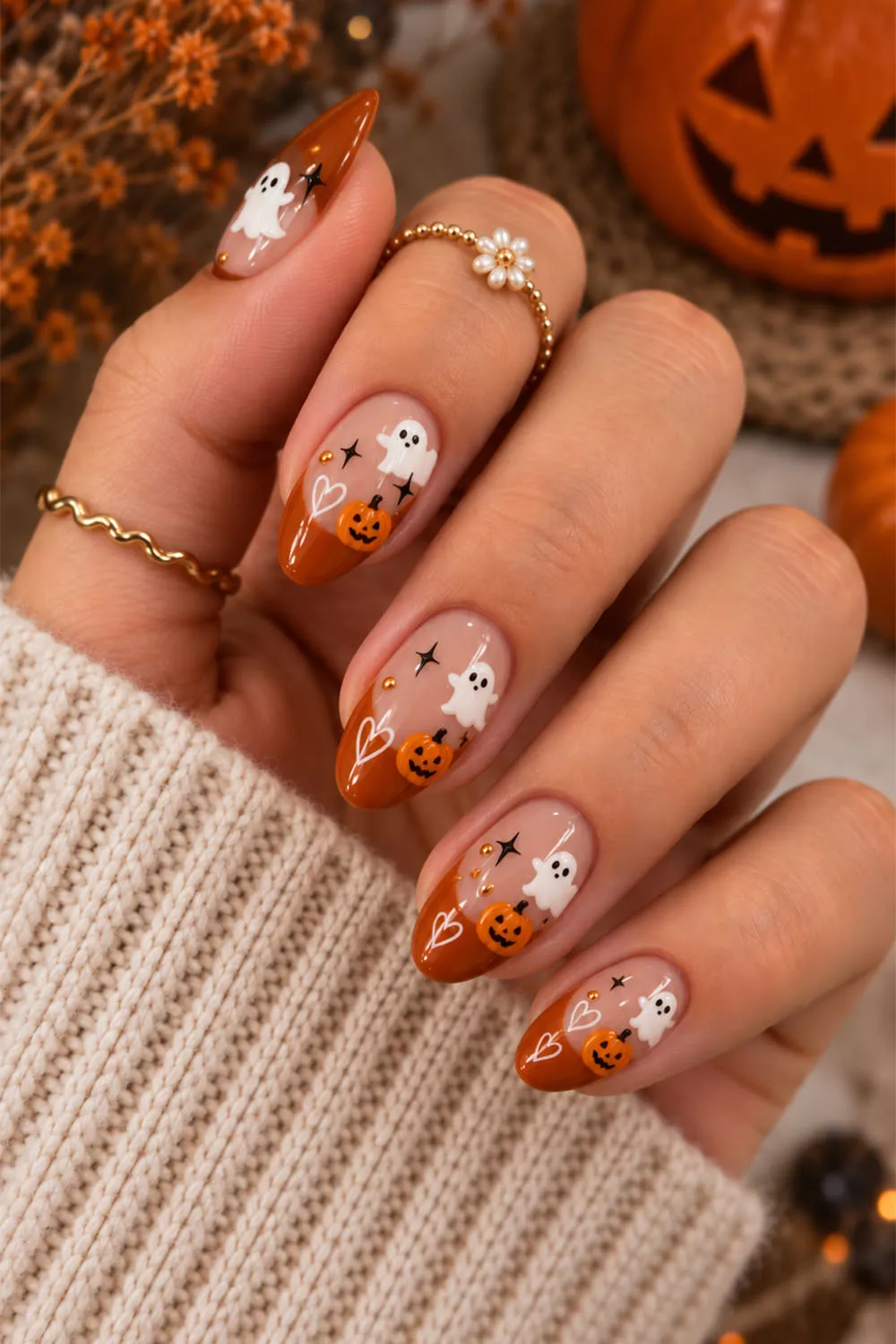 Short halloween nails in nude and orange with ghost and pumpkin art