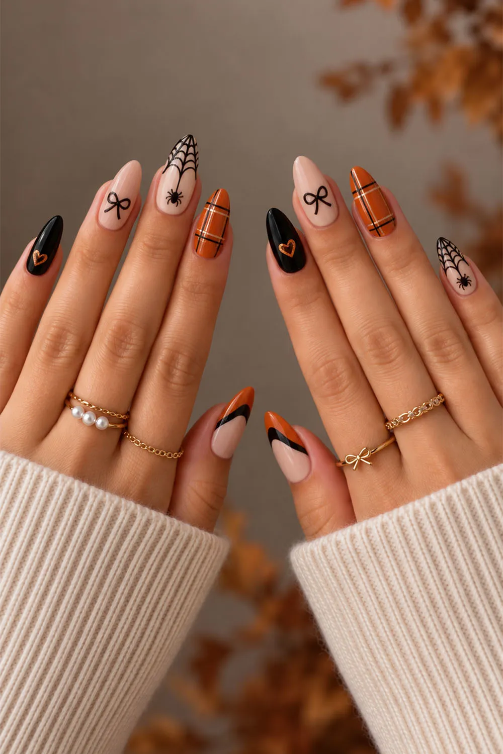 Short halloween nails with bows, plaid and spiderweb art in orange and black