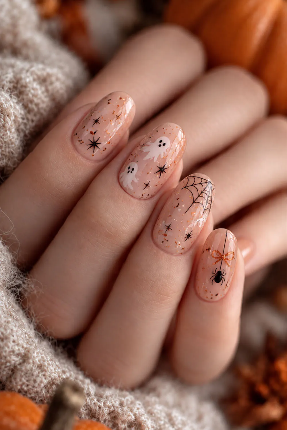 Sheer nude short halloween nails with tiny spiders, webs and stars
