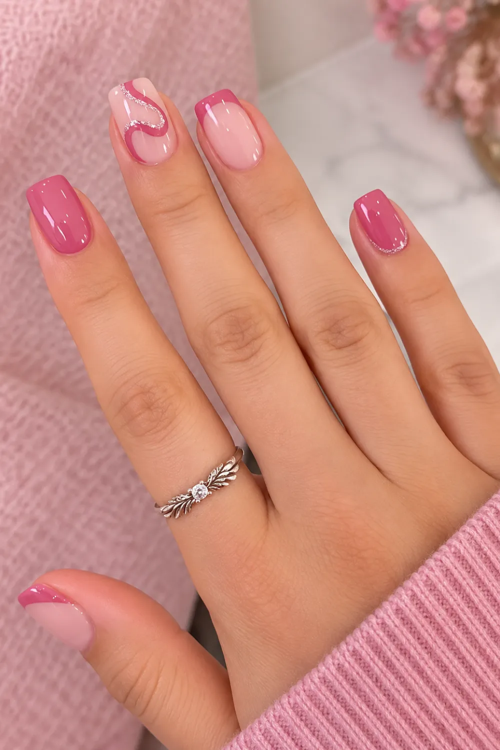 Short pink nails with a soft swirl marble design Short pink nails with a soft swirl marble design
