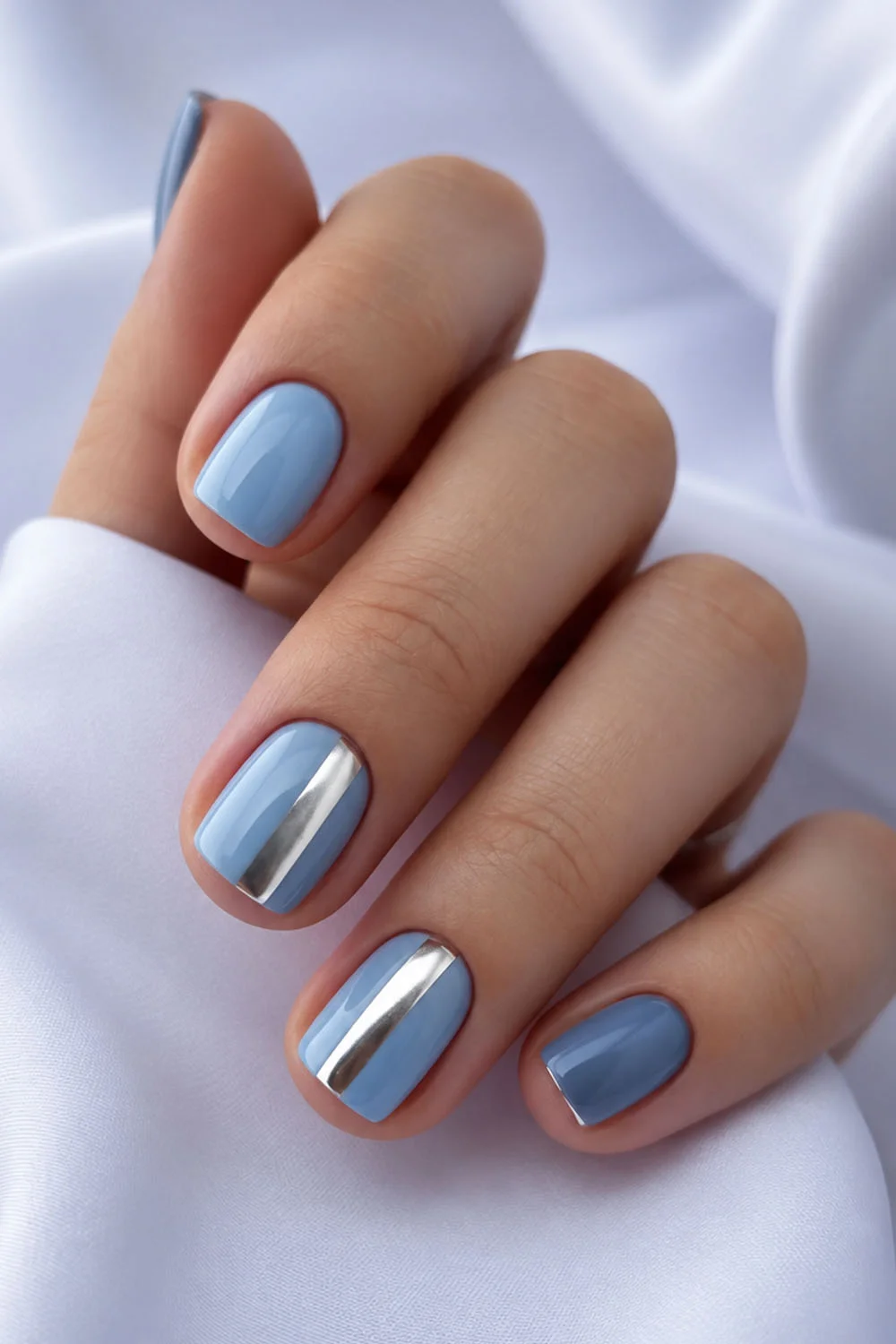 Summer nails in shades of blue with a silver chrome stripe accent Summer nails in shades of blue with a silver chrome stripe accent