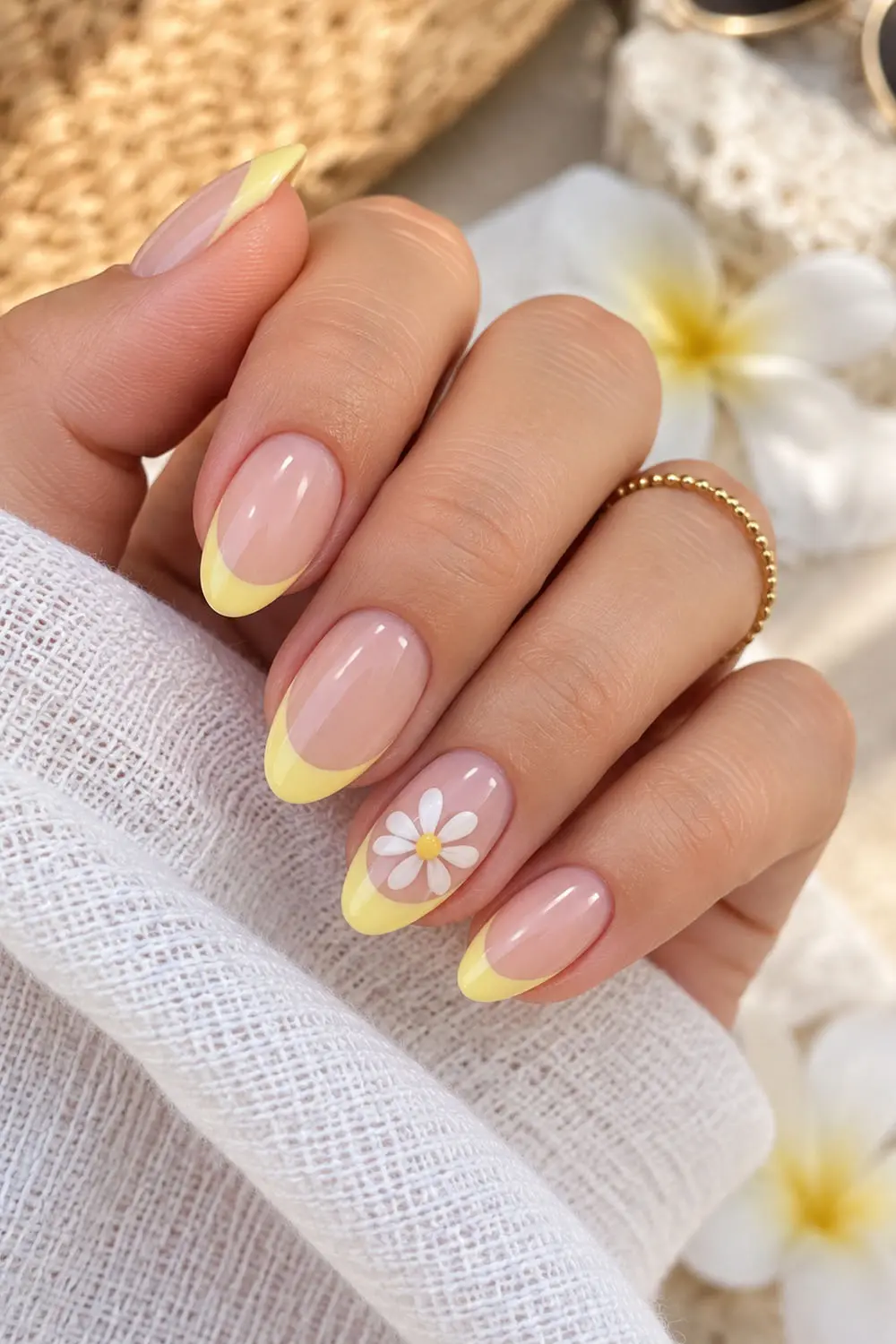 Summer nails with pastel yellow french tips and a small daisy accent Summer nails with pastel yellow french tips and a small daisy accent